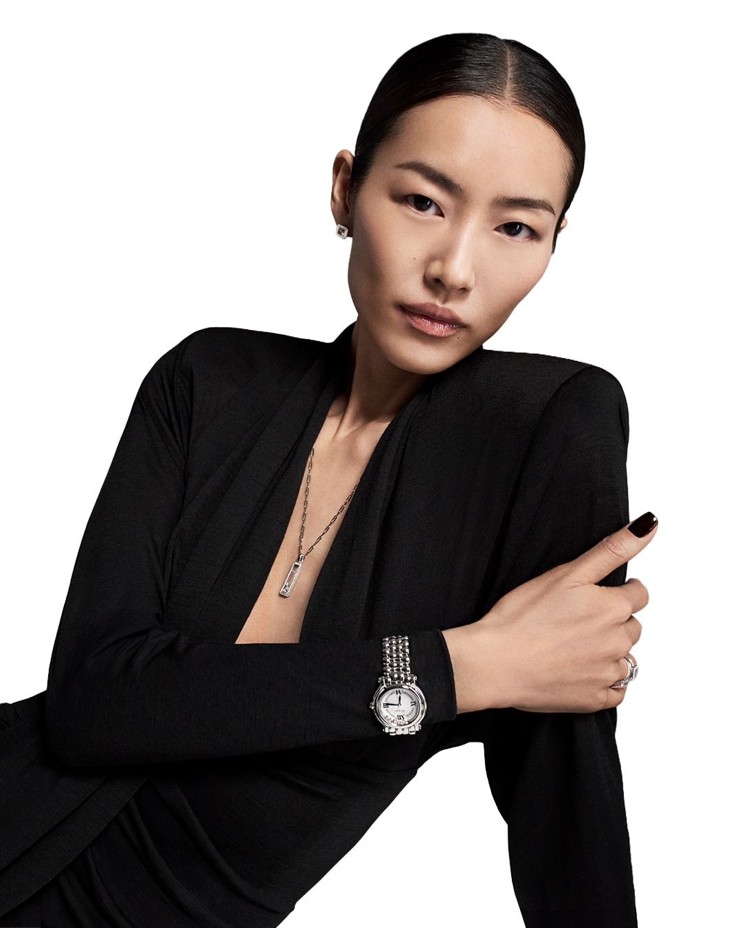 Liu Wen in black, oxblood nails, Chopard Happy Sport watch and Happy Diamonds pendant