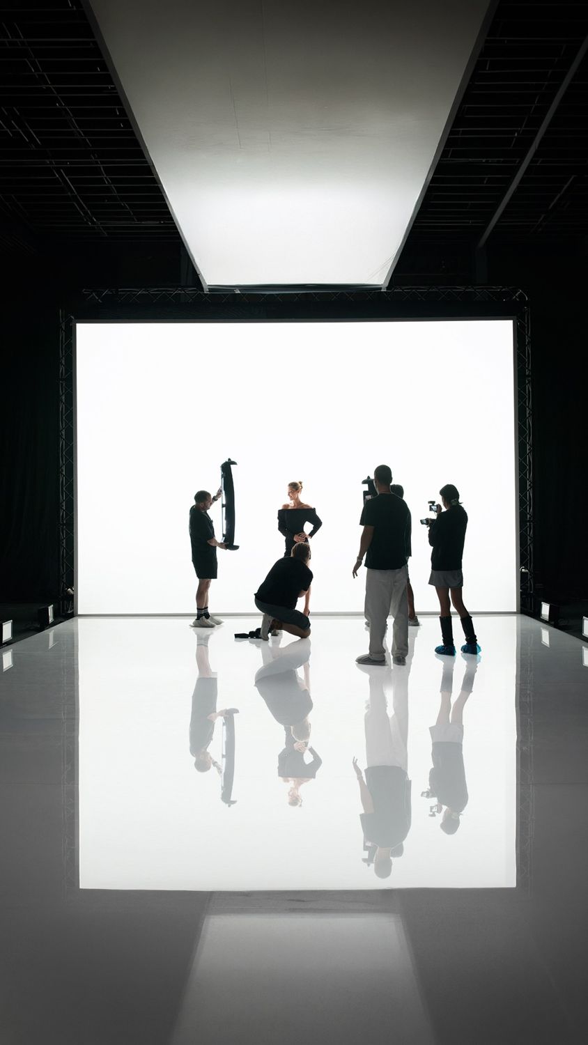 On set in Lisbon: crew silhouetted against a white cyclorama