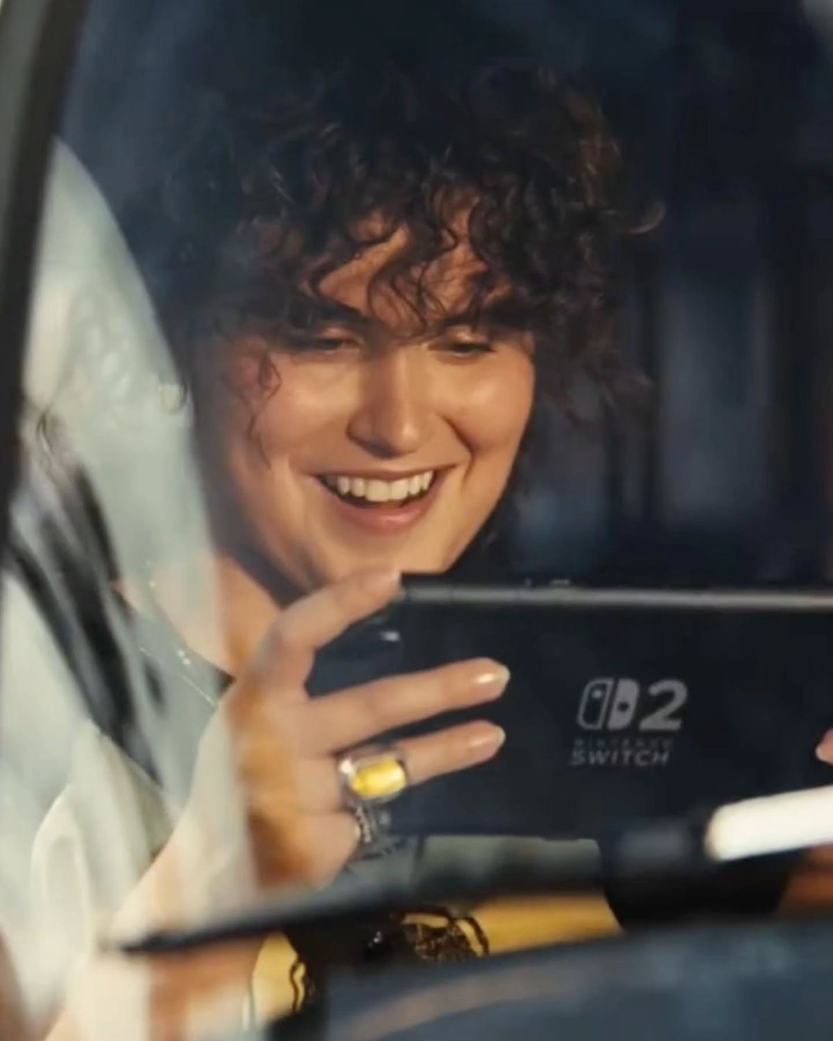 Woman laughing while playing a Nintendo Switch 2